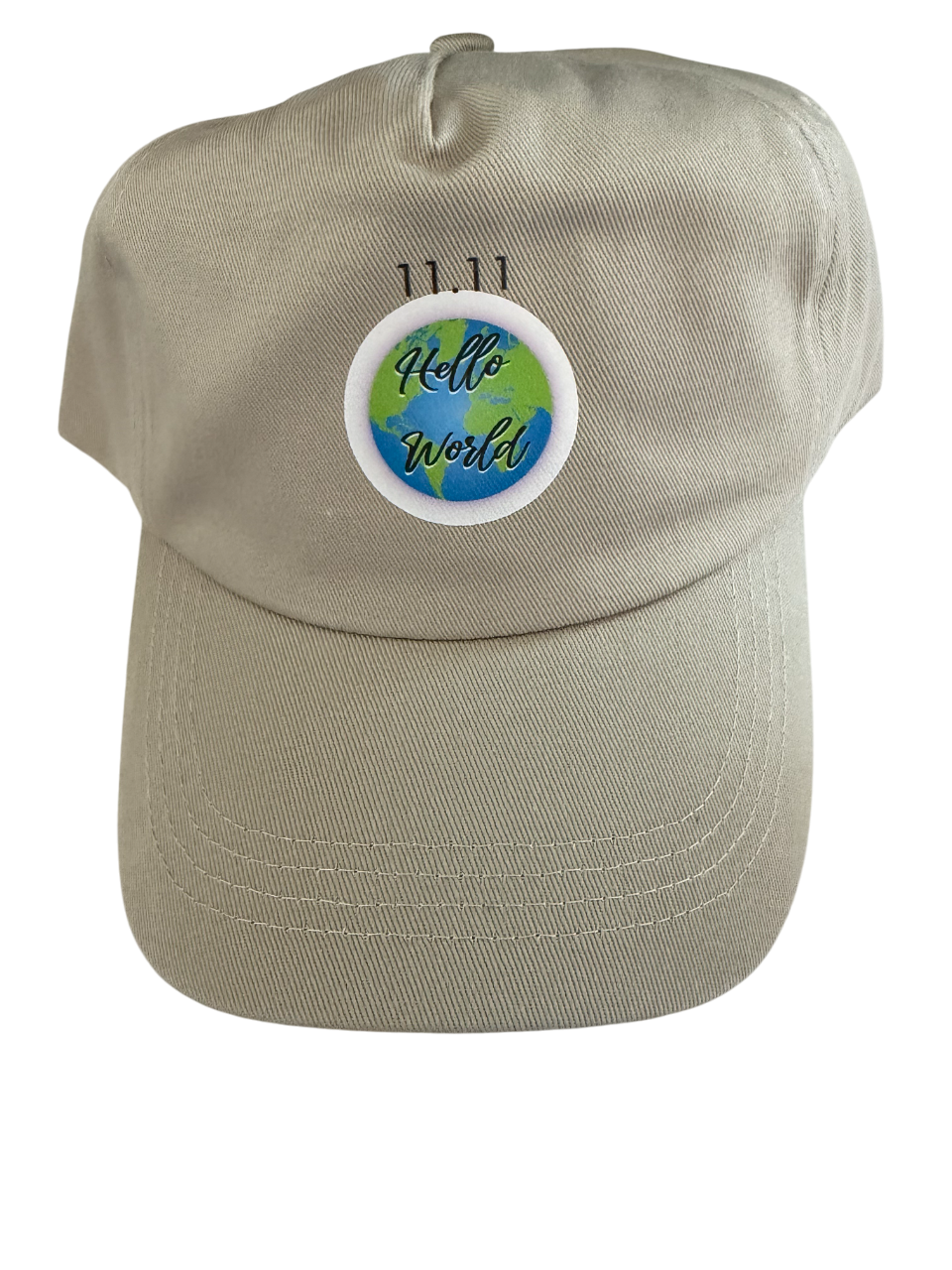Beige cap with "11.11" above a circular "Hello World" globe design.