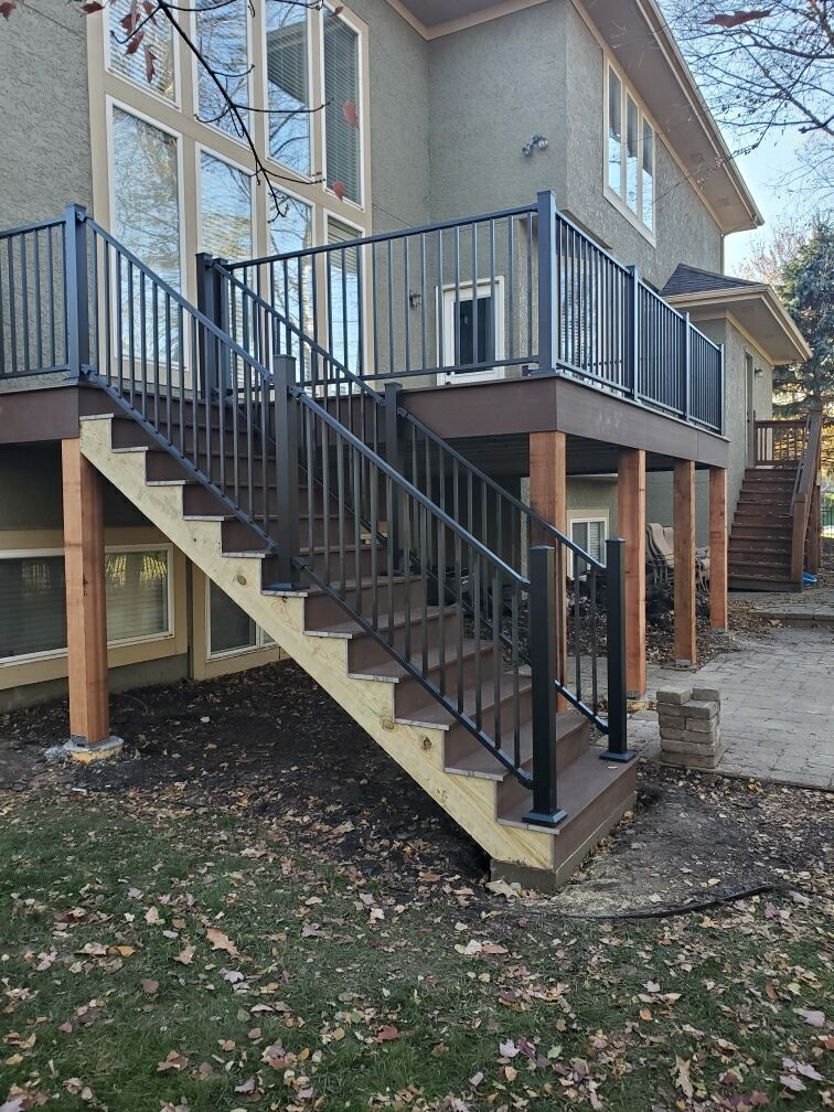 A house with a deck and stairs leading up to it