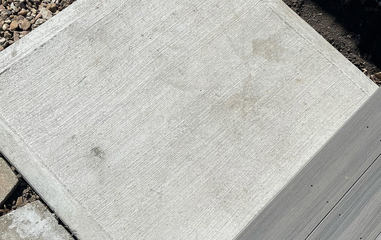 A close up of a concrete block on a sidewalk.