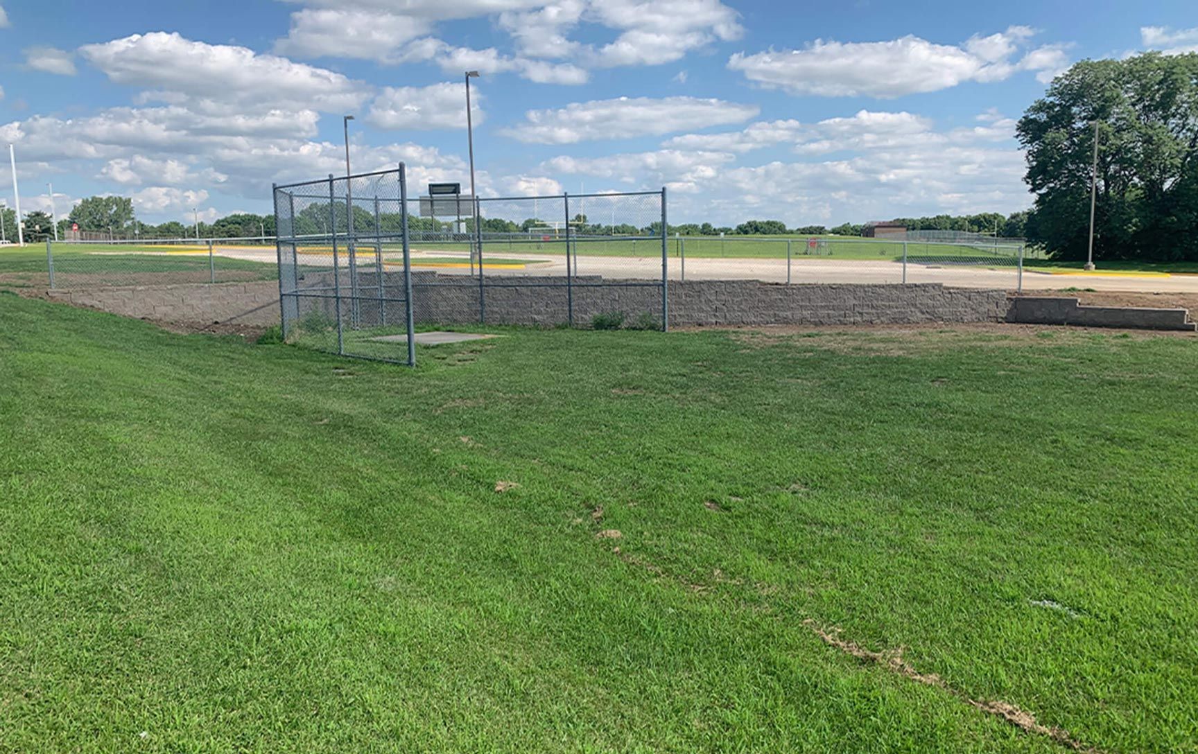 A baseball field with a fence in the middle of it.