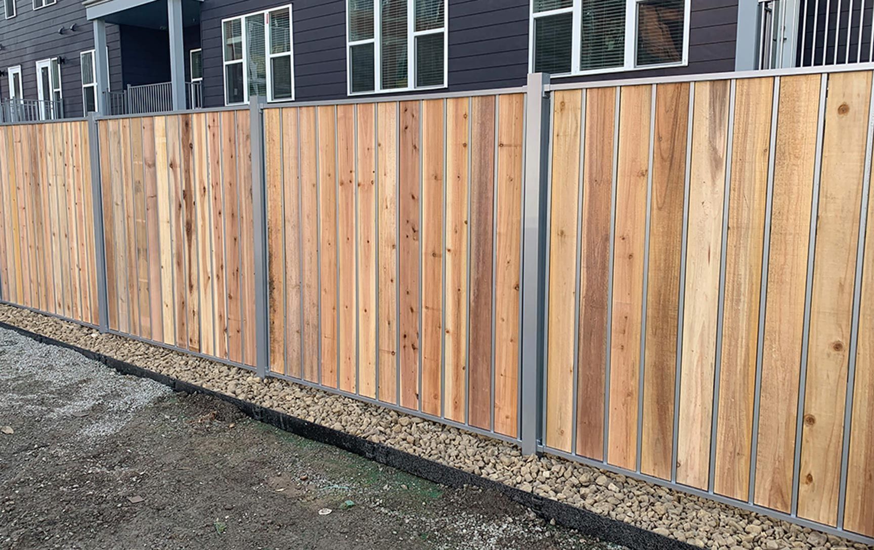 A wooden fence is sitting in front of a building.