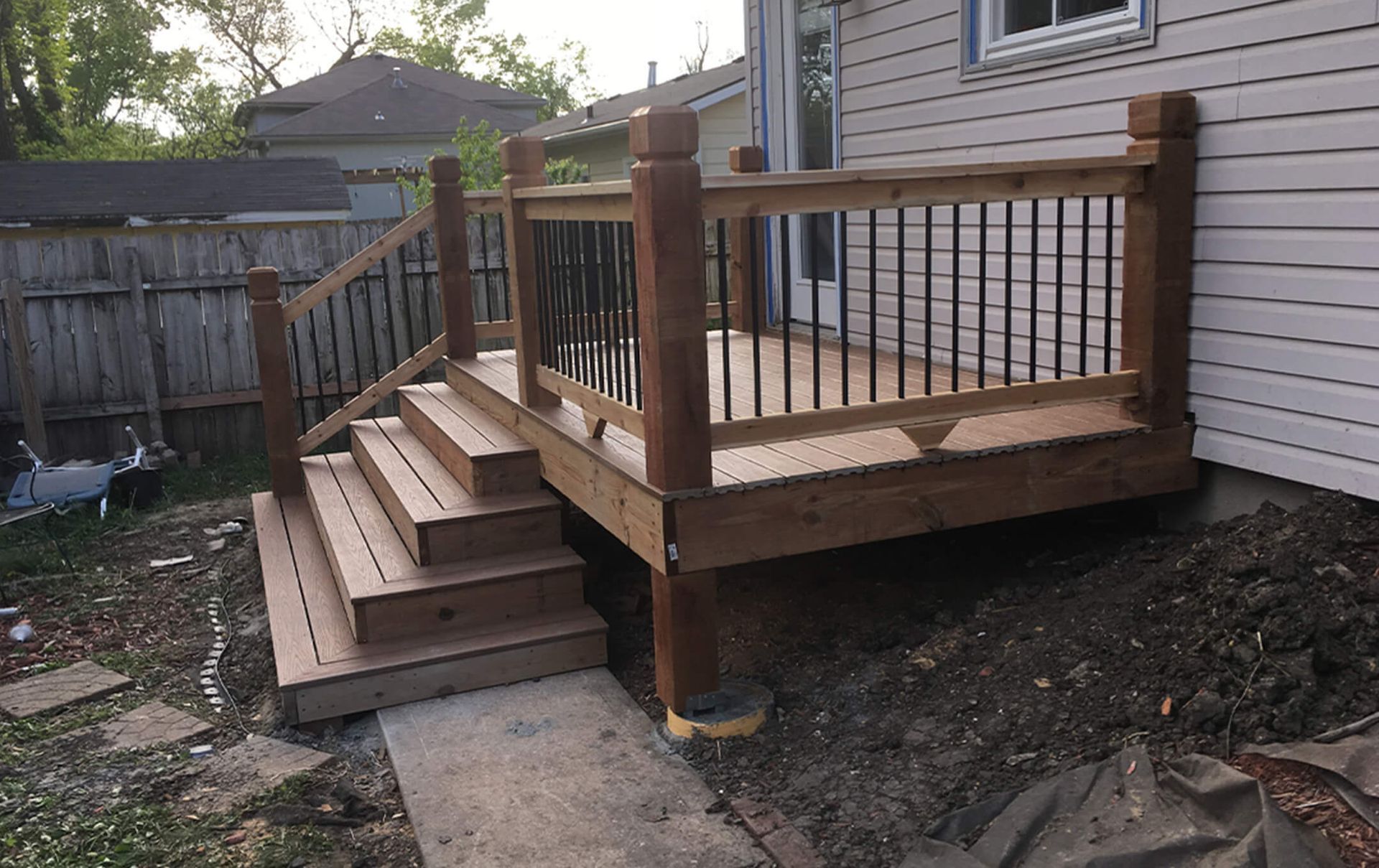 A wooden deck with stairs leading up to it