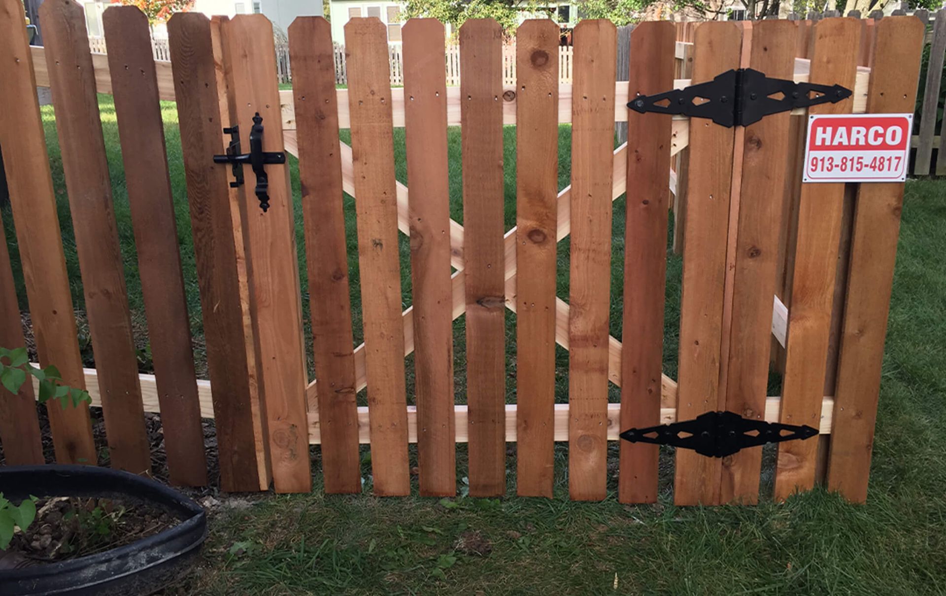 A wooden fence with a sign that says marco on it