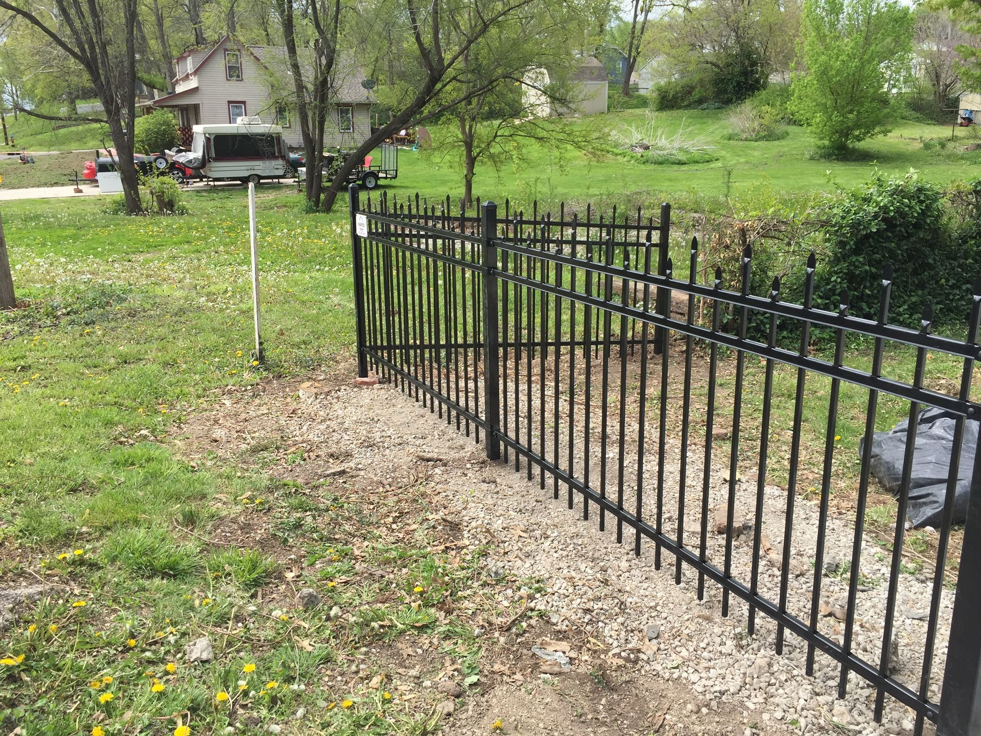 A close up of a wrought iron fence on a bridge.