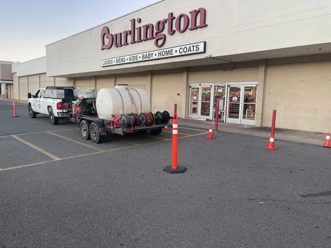 Burlington store entrance with parked trailer, white truck, and orange traffic cones in front