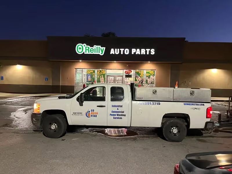 White pickup truck parked outside O’Reilly Auto Parts at night
