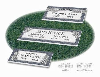 Three grave markers are sitting on top of a lush green field.