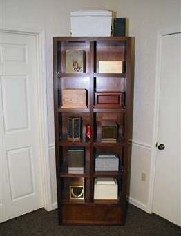 A bookshelf with a lot of boxes on it