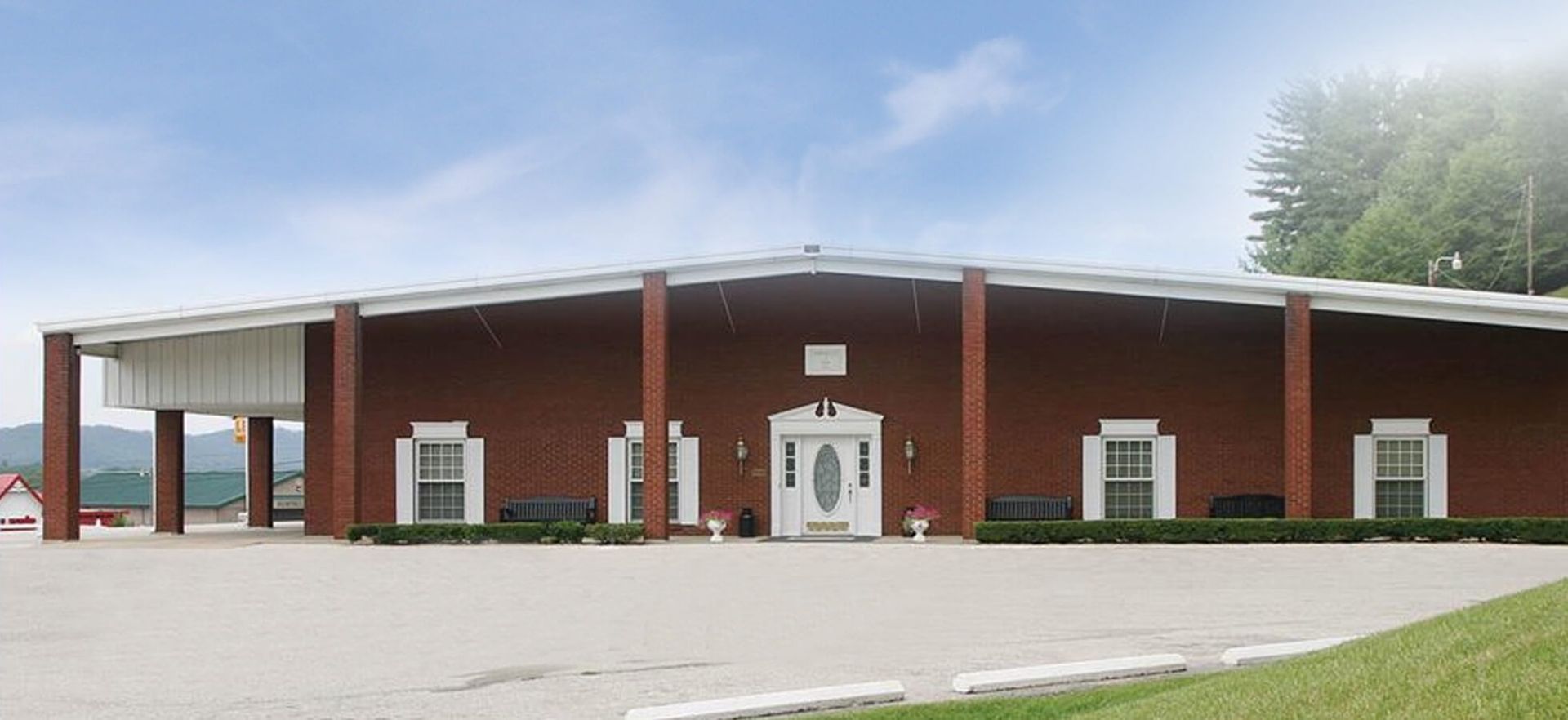 A large red brick building with a white roof