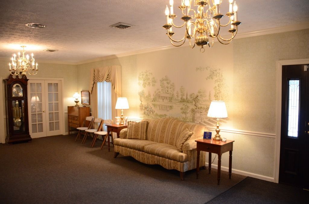 A living room with a couch and a chandelier