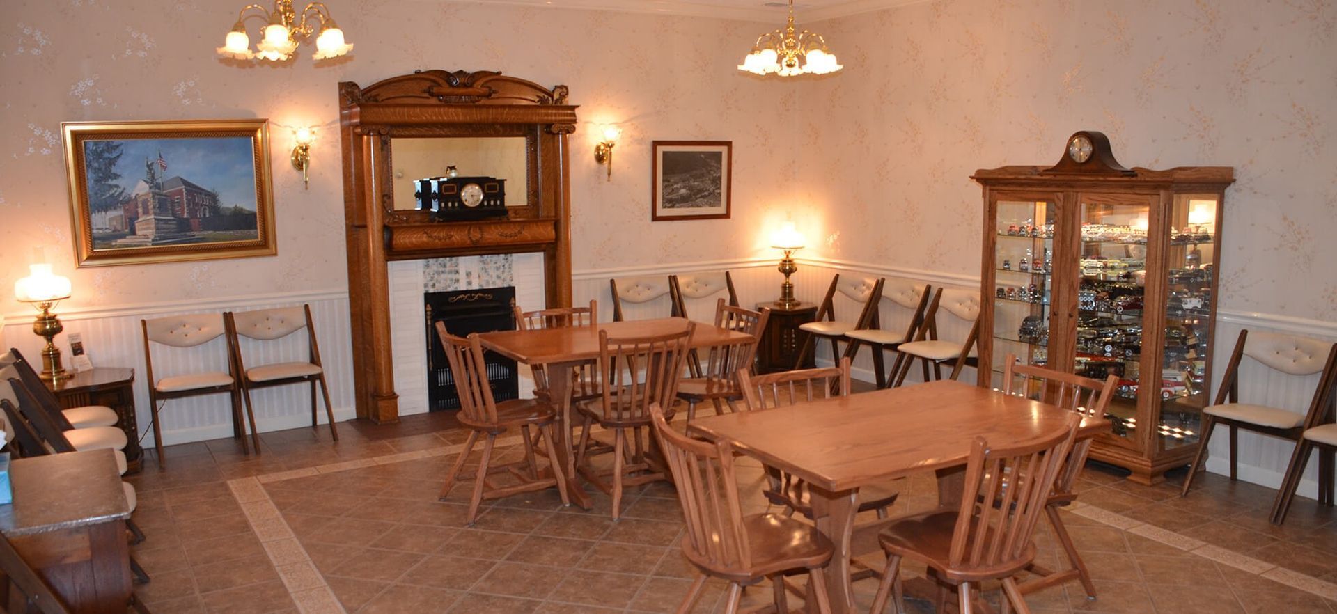 A room with tables and chairs and a fireplace