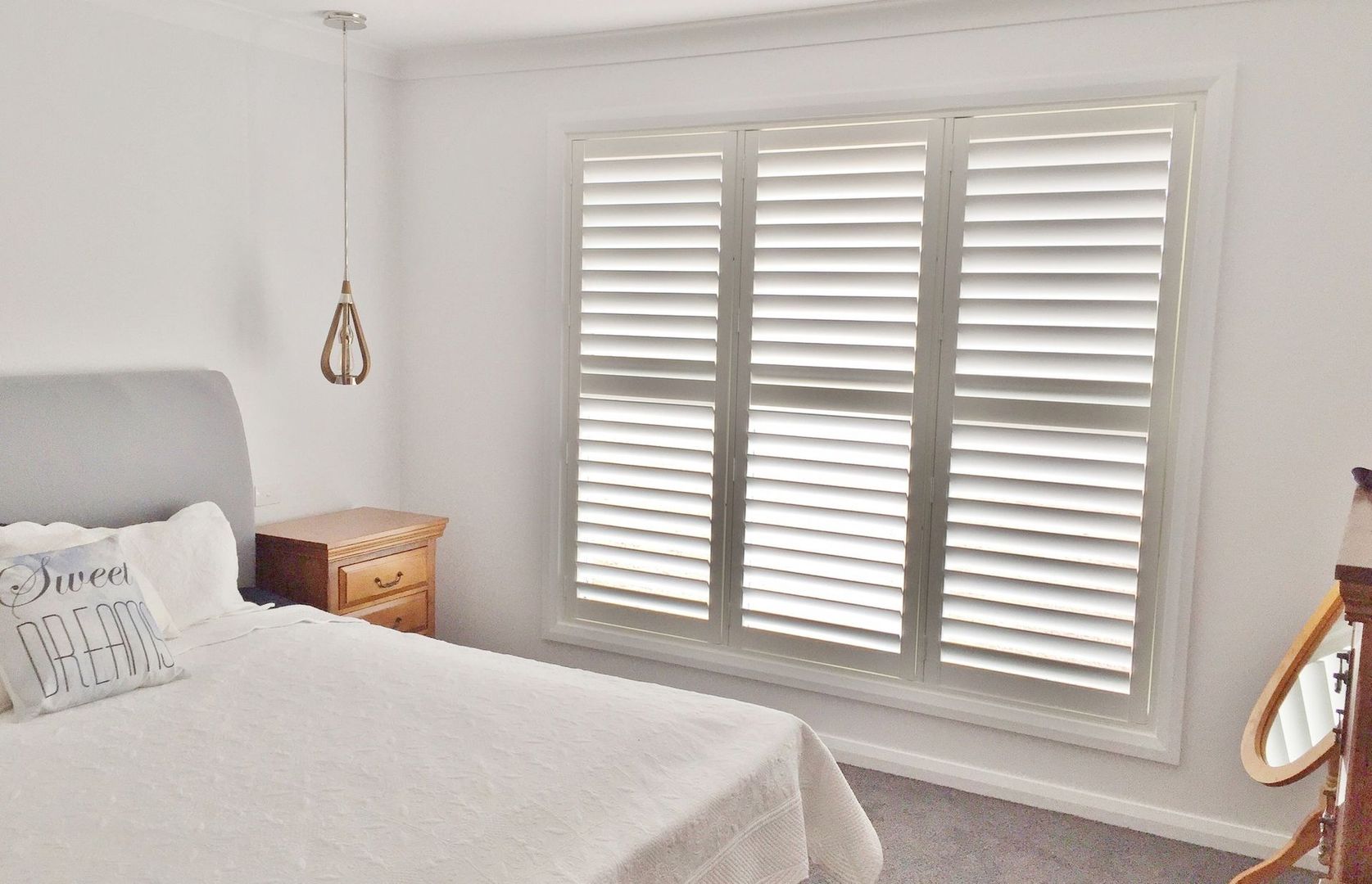 white shutters in a bedroom