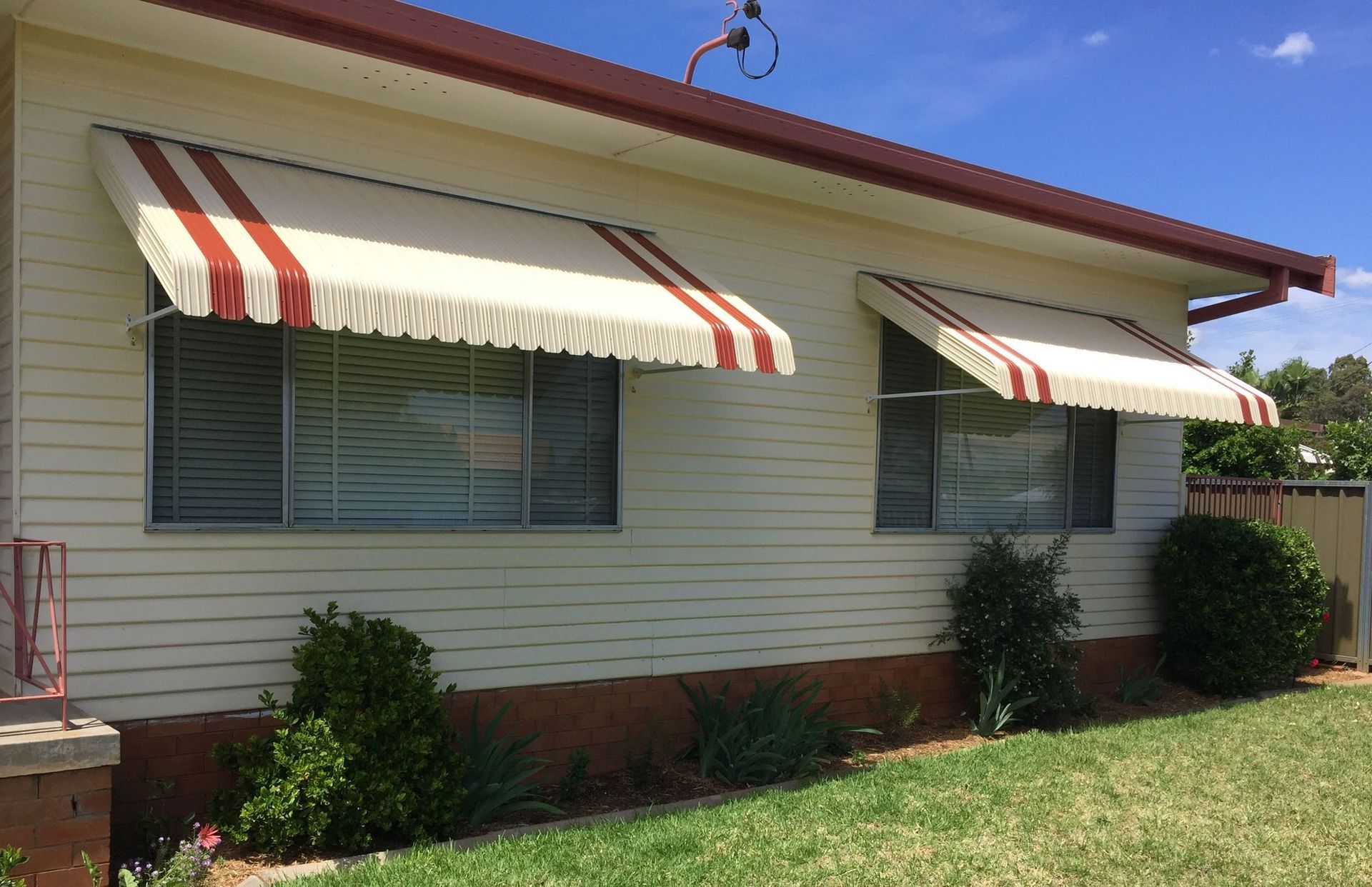 Accent striped steel awnings on the exterior of a home