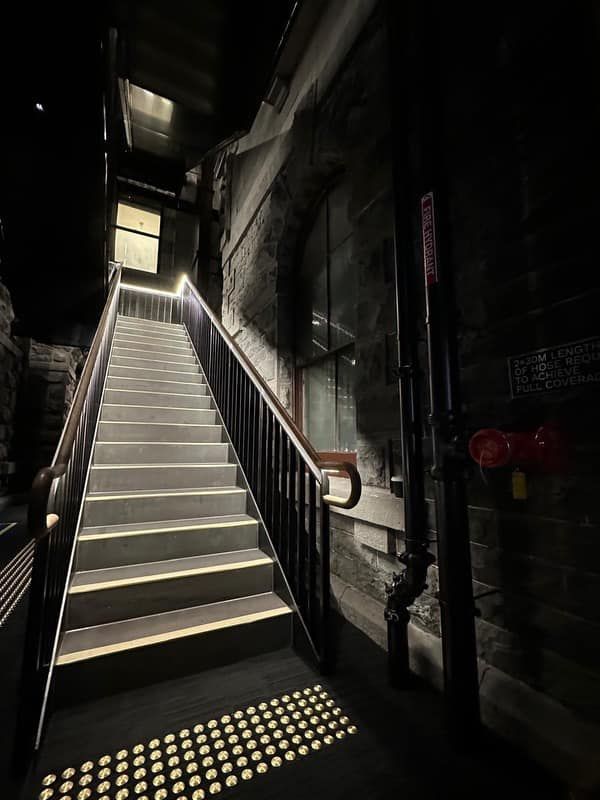 A set of stairs leading up to a building at night.