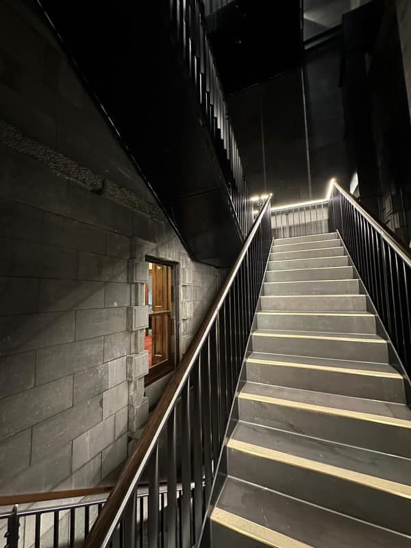 A set of stairs leading up to a building at night.
