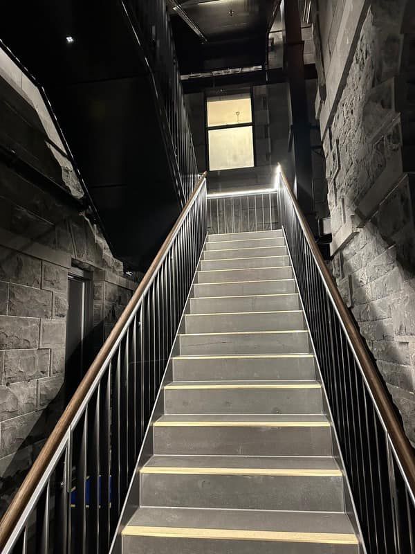 A set of stairs leading up to a building with a railing.