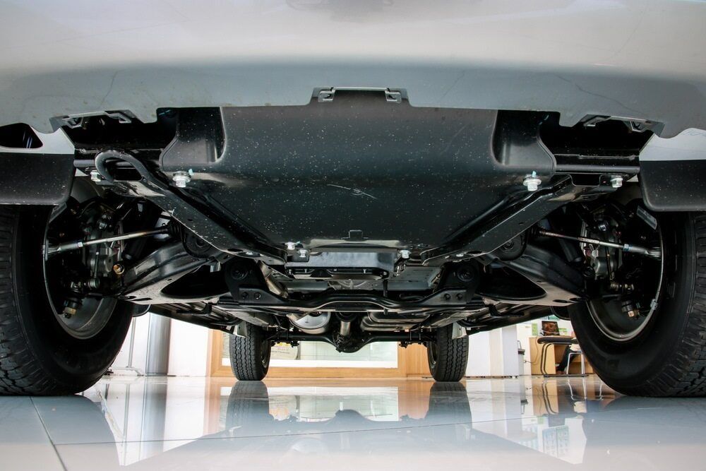the Underside of a Car is Shown in a Garage — Wayne Boylett Mechanical In Bungalow, QLD the Underside of a Car is Shown in a Garage — Wayne Boylett Mechanical In Bungalow, QLD