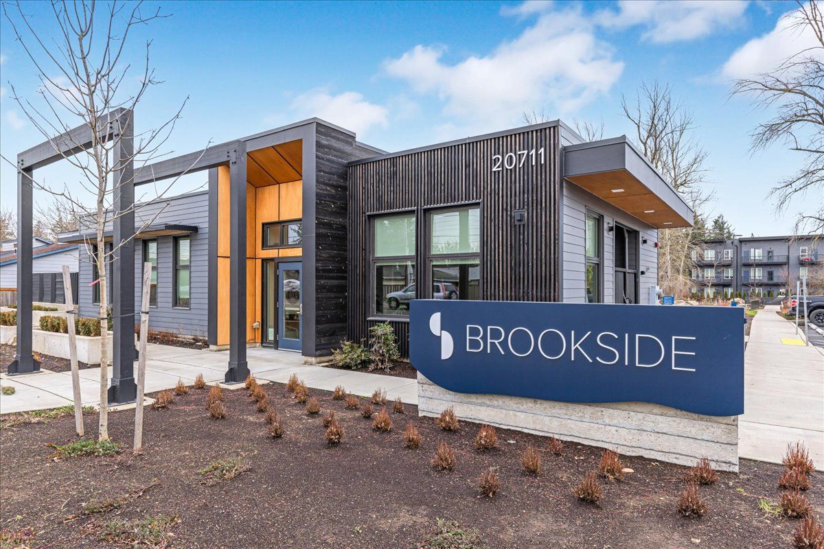 a building with a sign that says brookside in front of it .
