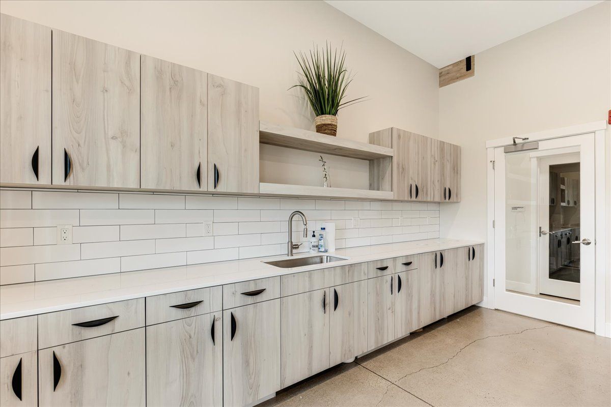 a kitchen with wooden cabinets and a sink .