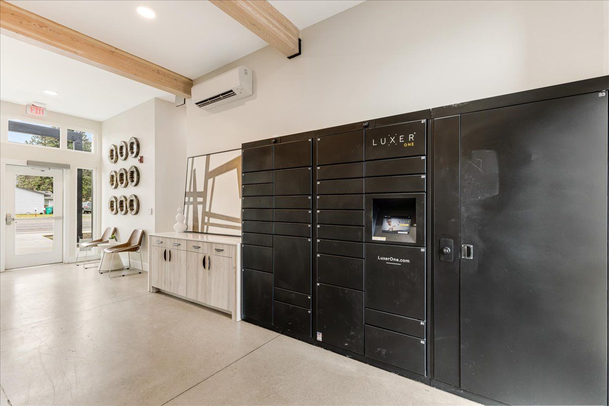 a room with a lot of black lockers and a printer .