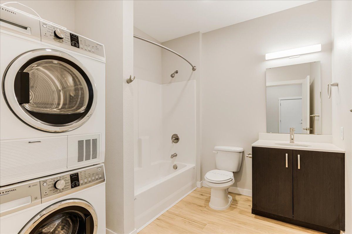 a bathroom with a washer and dryer and a toilet .