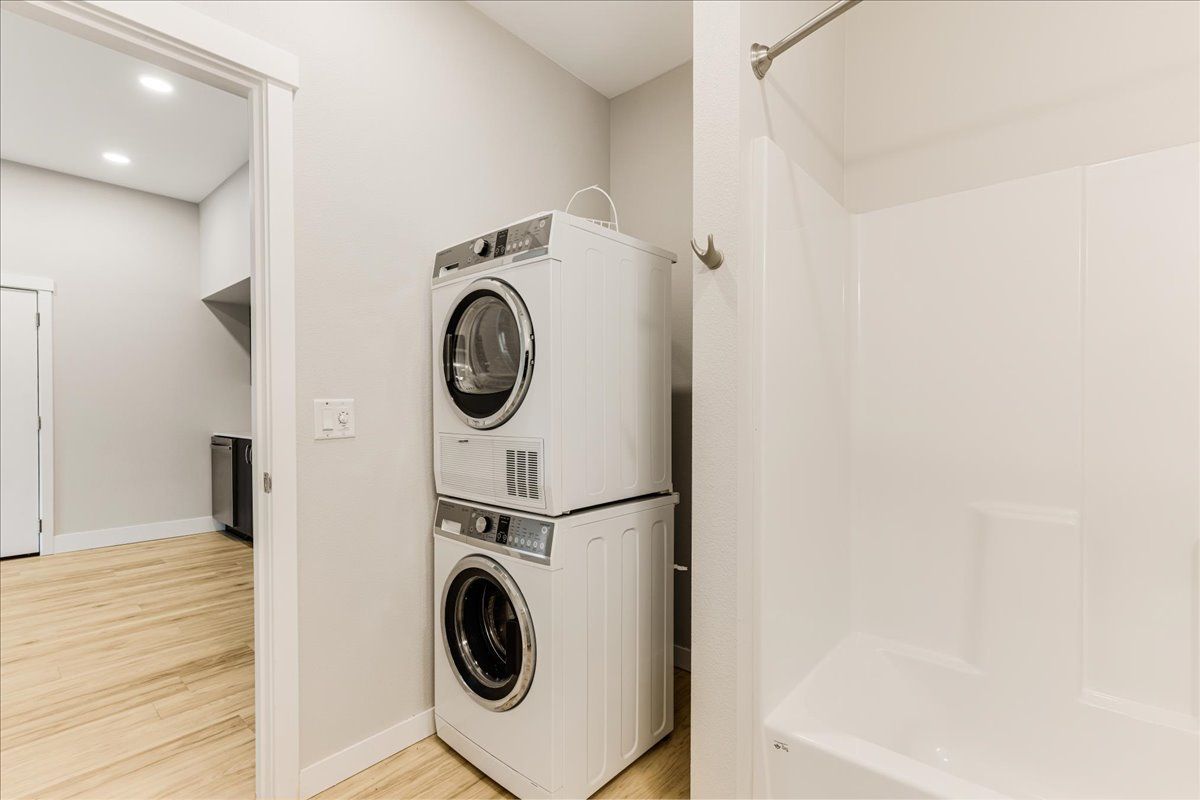 a washer and dryer are stacked on top of each other in a bathroom .