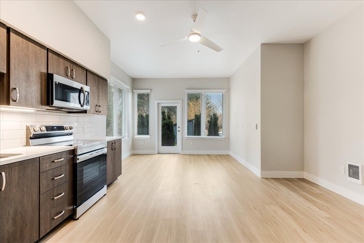 a kitchen with stainless steel appliances and wooden cabinets
