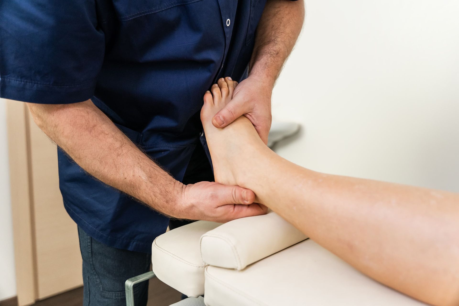 A person's foot being examined by a healthcare professional.