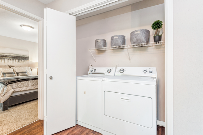 A laundry room with a washer and dryer in a closet at Steeplechase Apartments in Knoxville, Tennessee