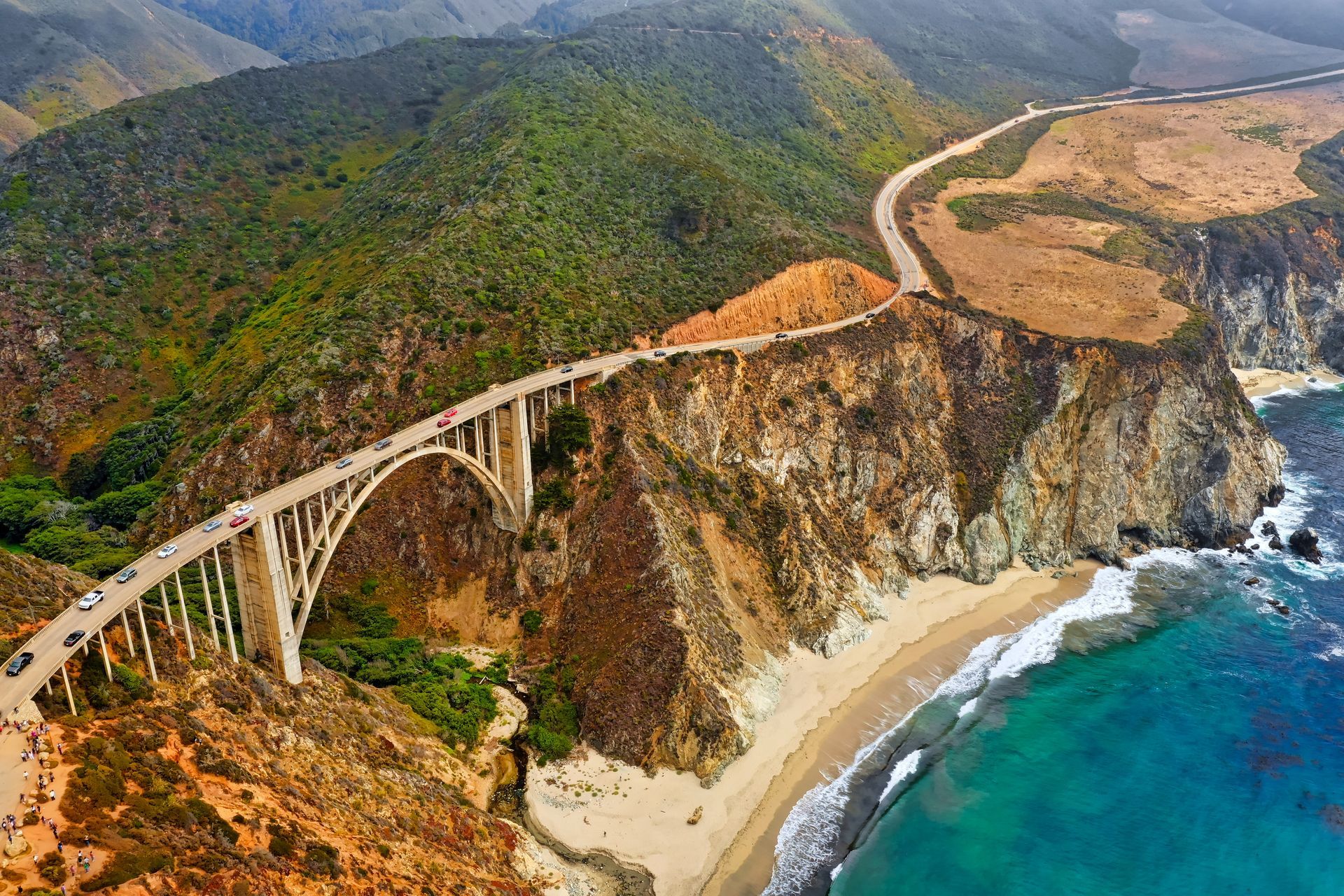 An aerial view of a bridge over a body of water.