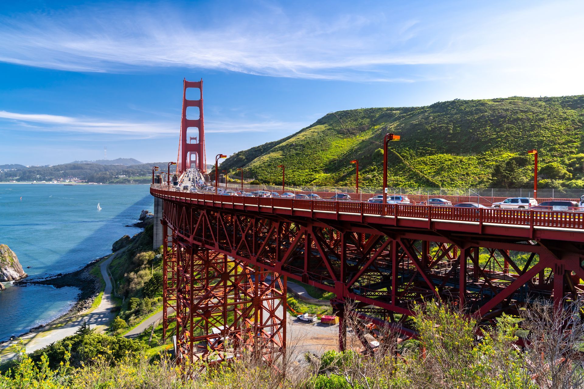 The golden gate bridge is a red bridge over a body of water.