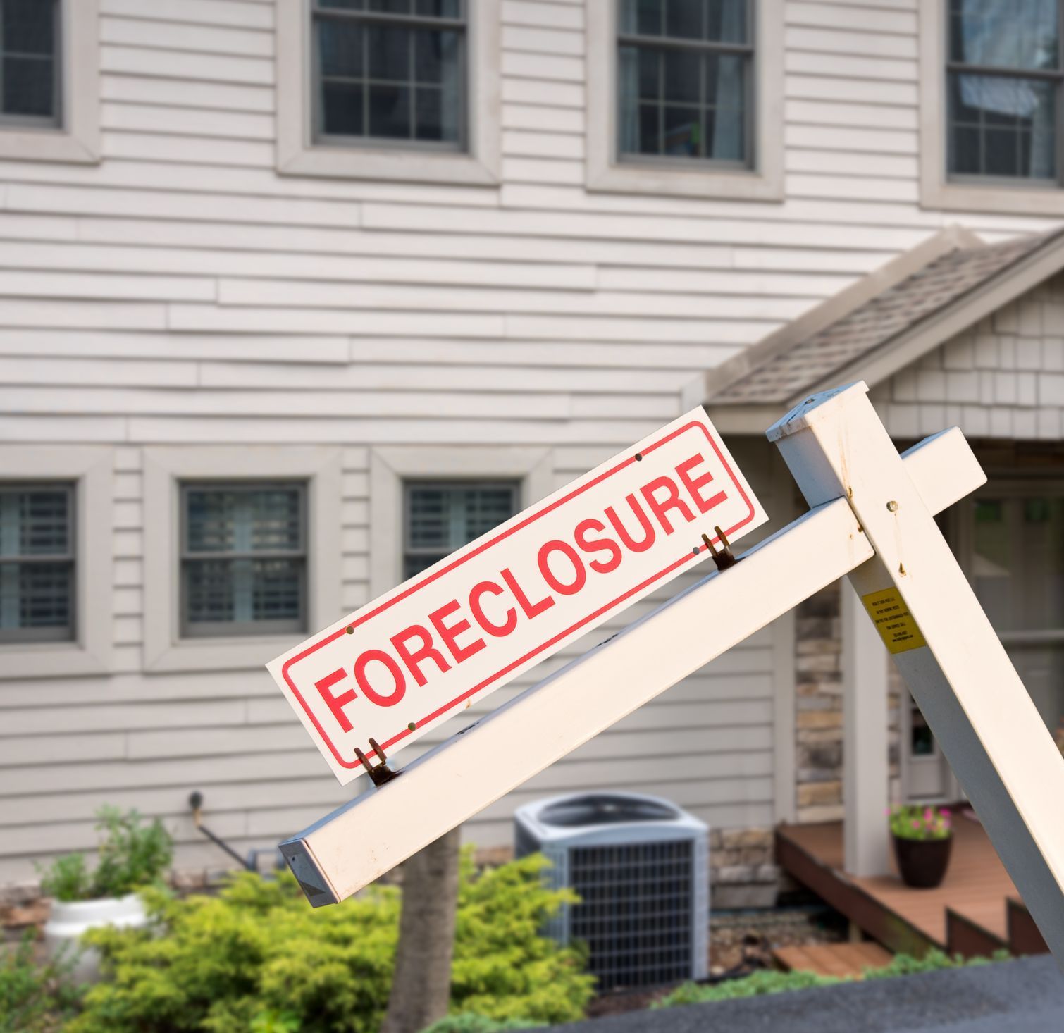 A foreclosure sign in front of a house