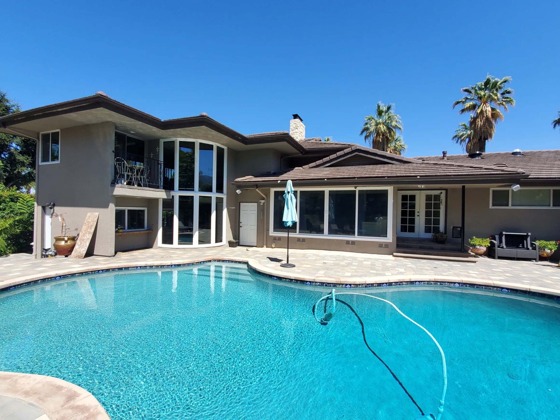 A large house with a swimming pool in front of it