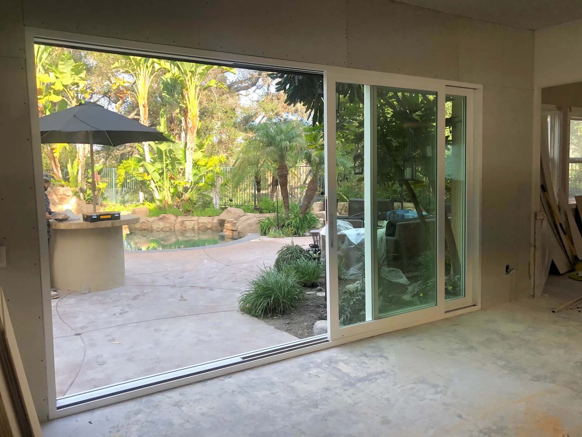 A large sliding glass door is open to a patio.