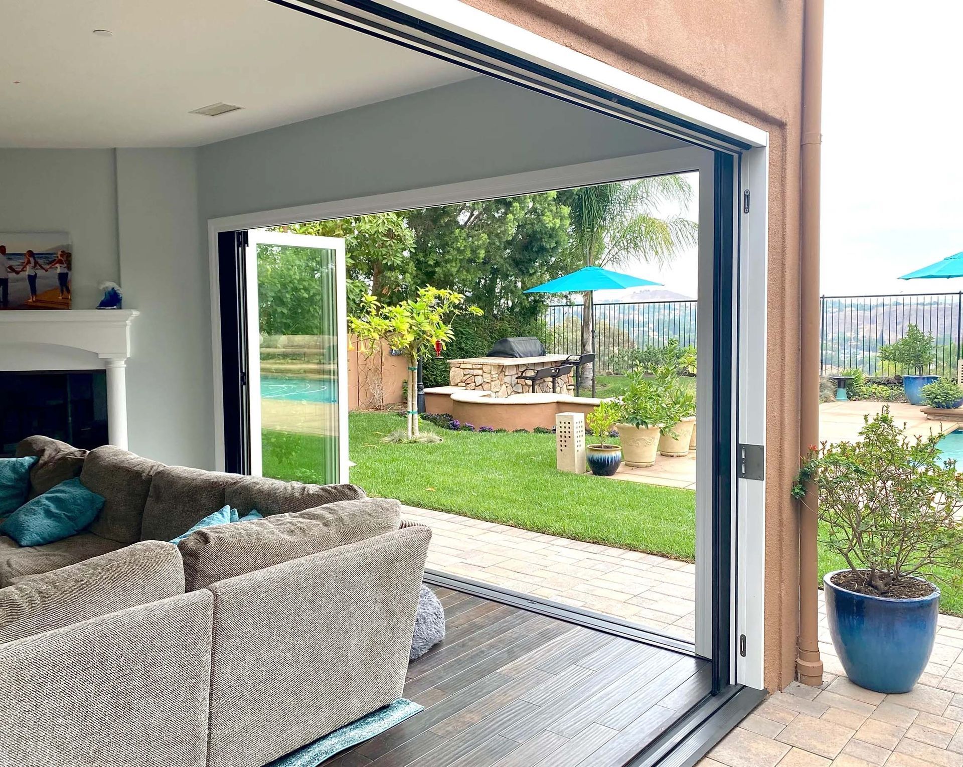 A living room with a couch and sliding glass doors leading to a backyard.