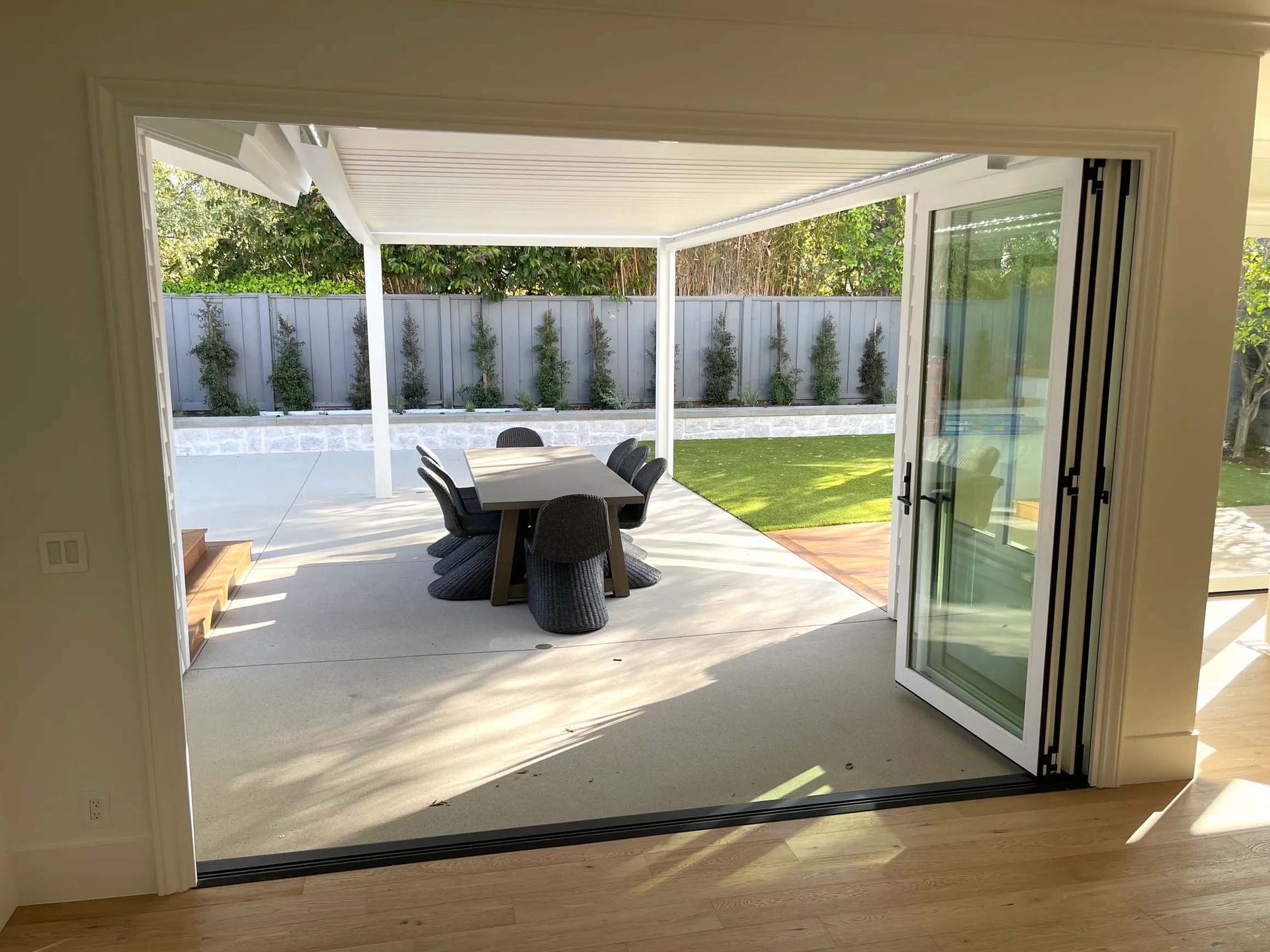A patio with a table and chairs under a canopy.
