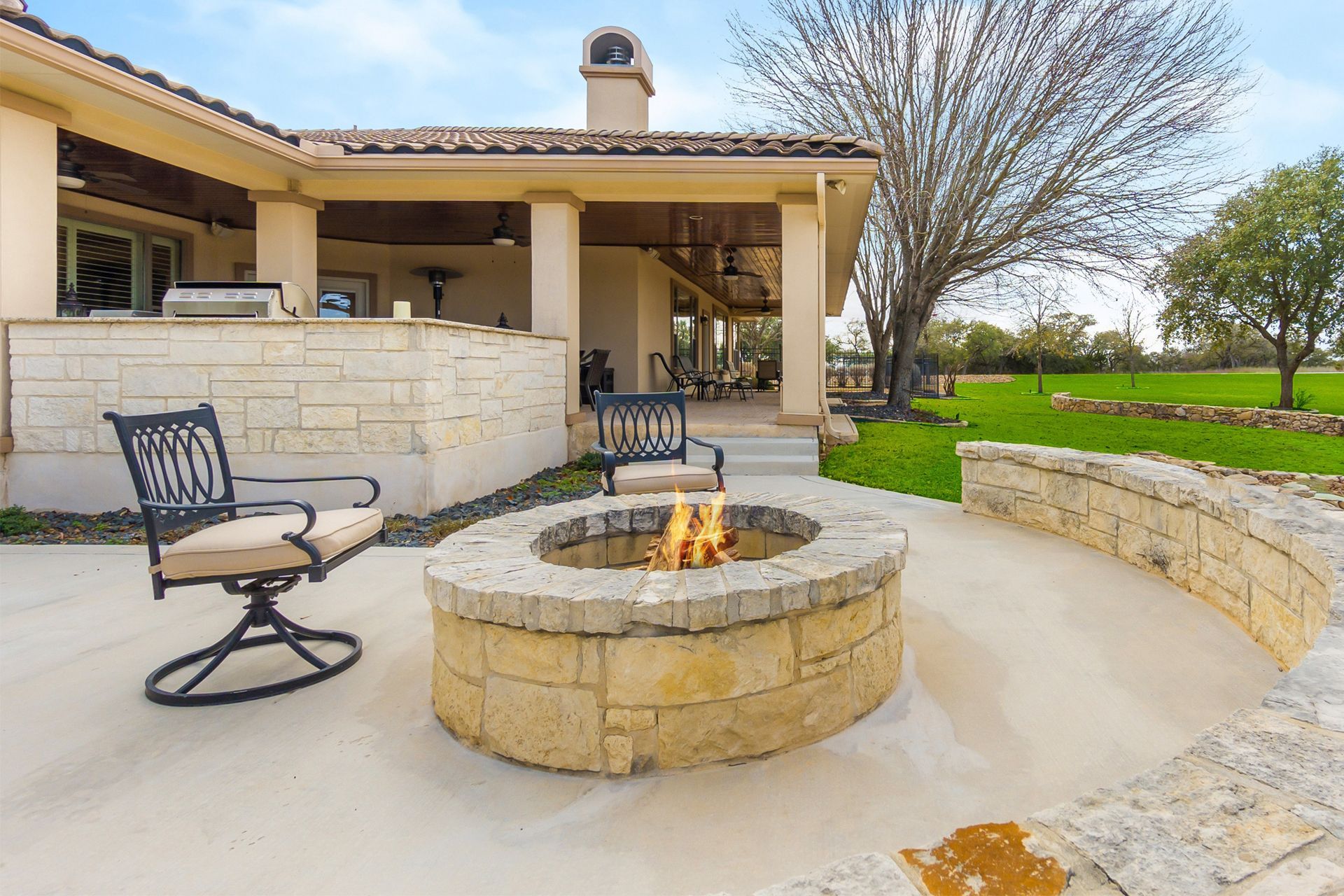 There is a fire pit in the middle of the patio