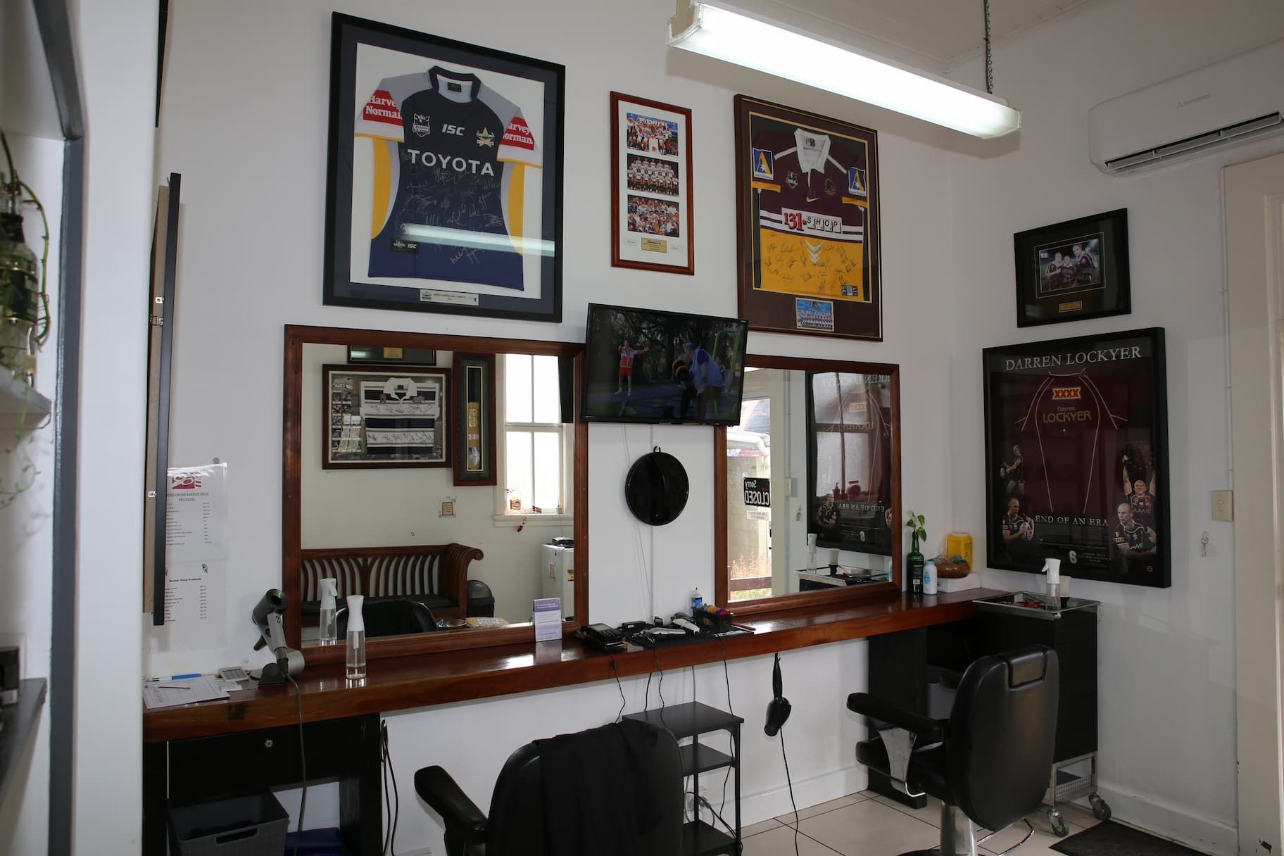 a north Queensland cowboys jersey hangs on a wall in a barber shop - barber shop Kingaroy