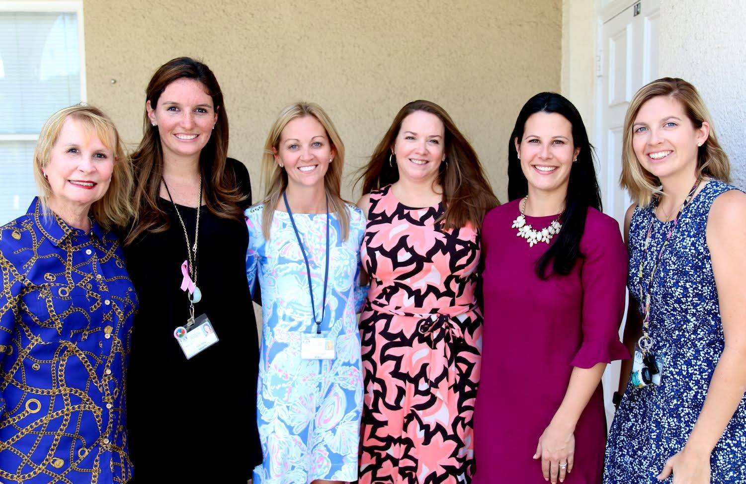 a group of women are posing for a picture together