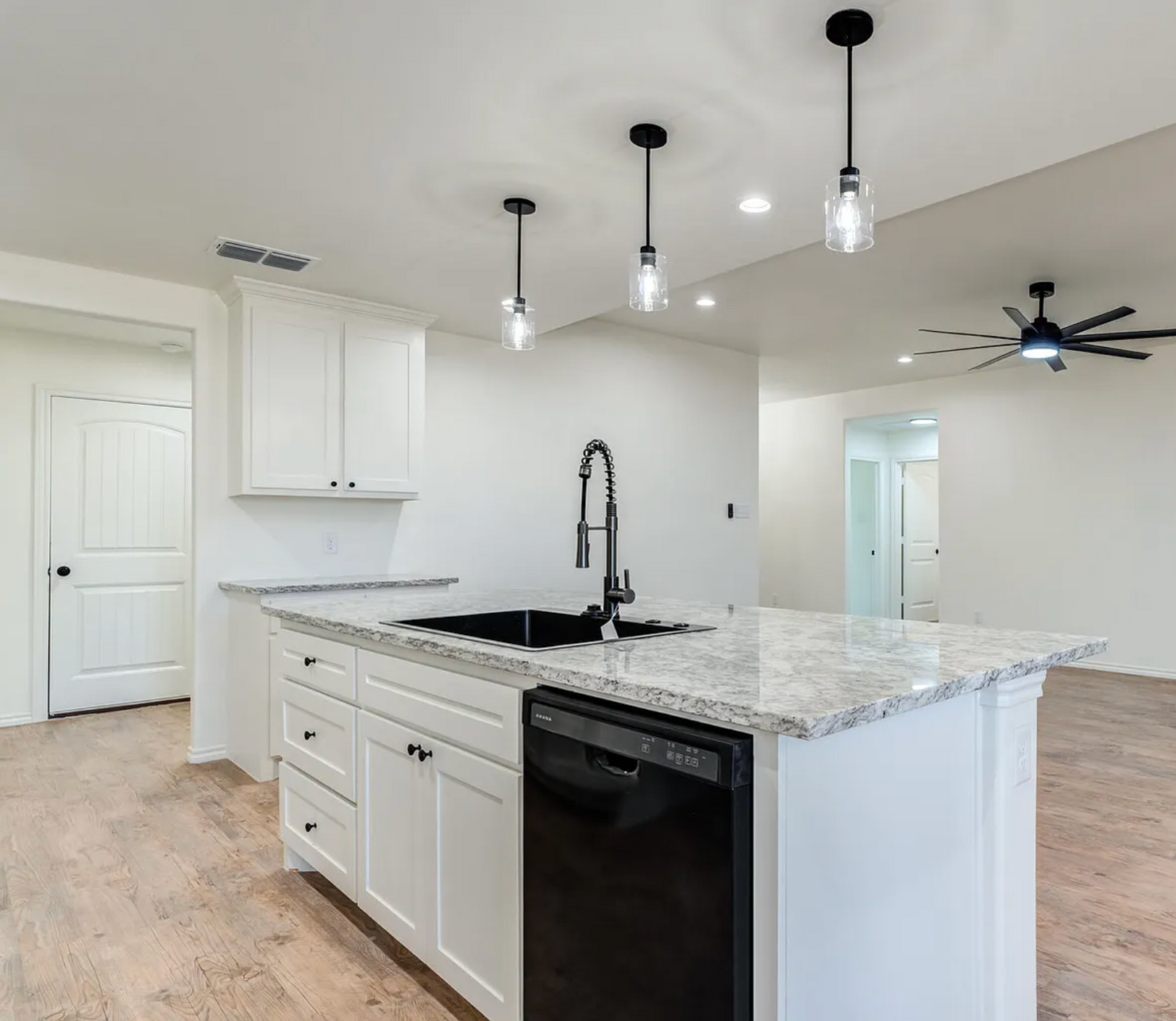 Laundry room with white cabinets, brick backsplash, wood countertops, and hexagonal tile floor.