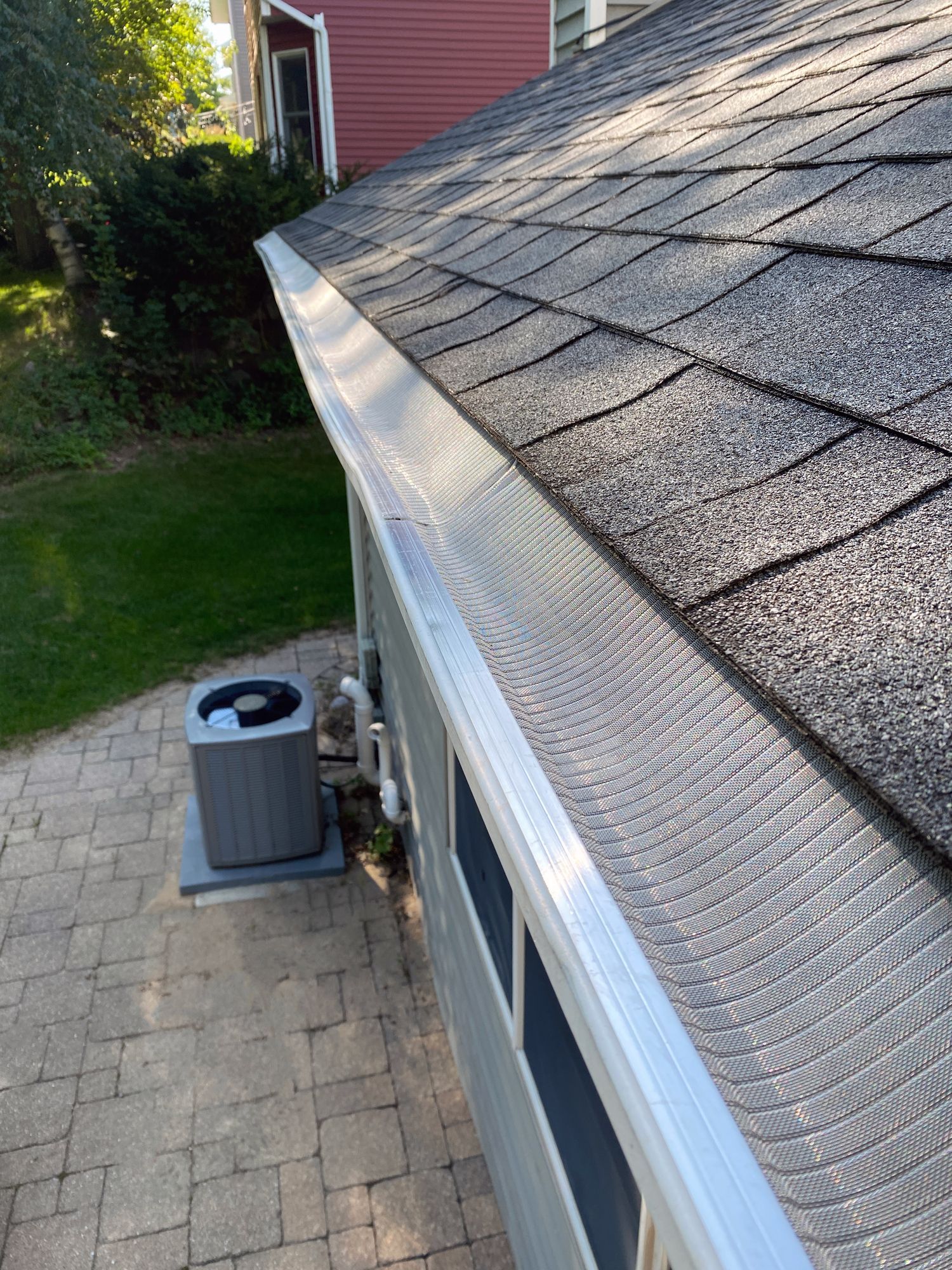 A close up of a gutter on the side of a house.