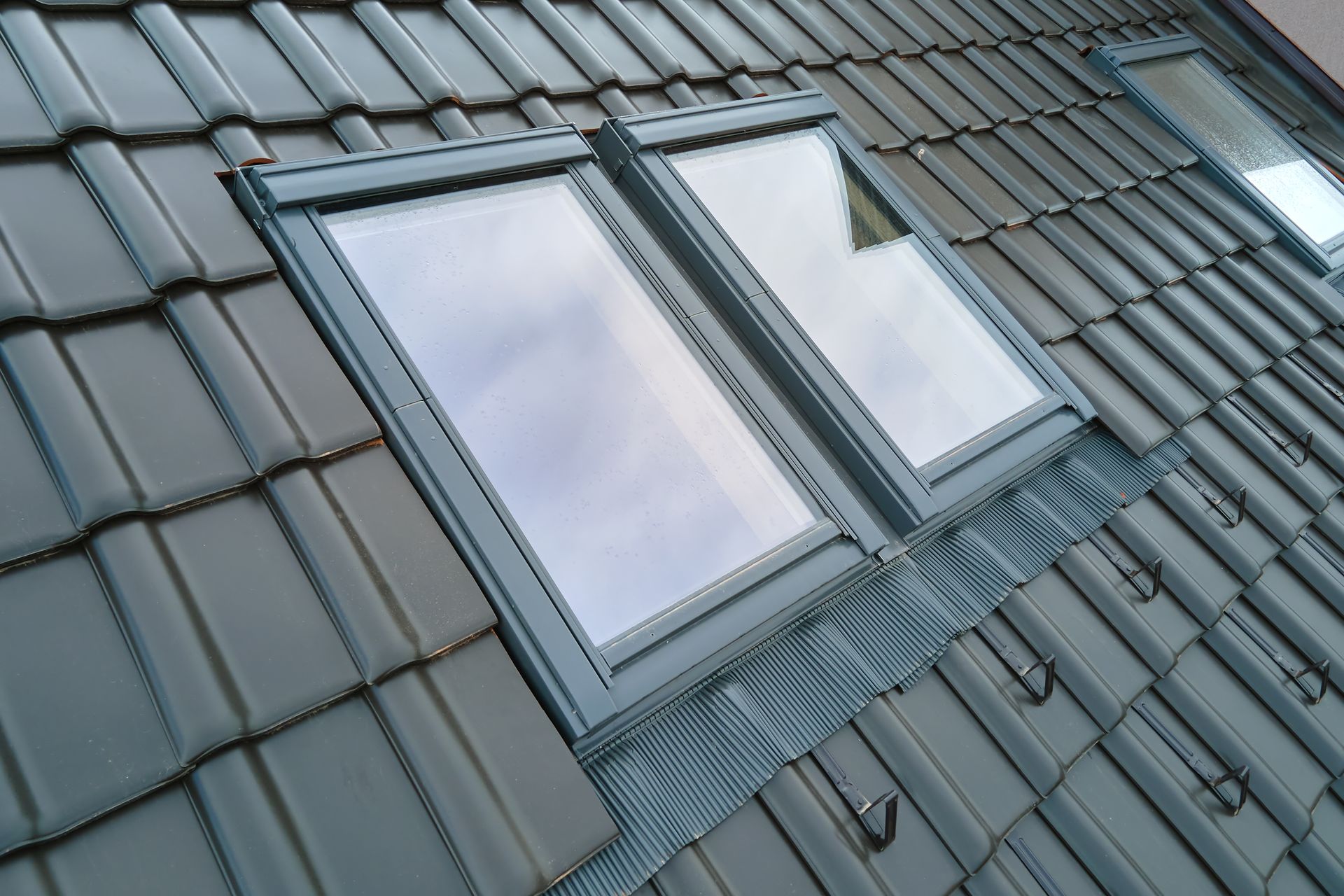 A roof with two skylights on it