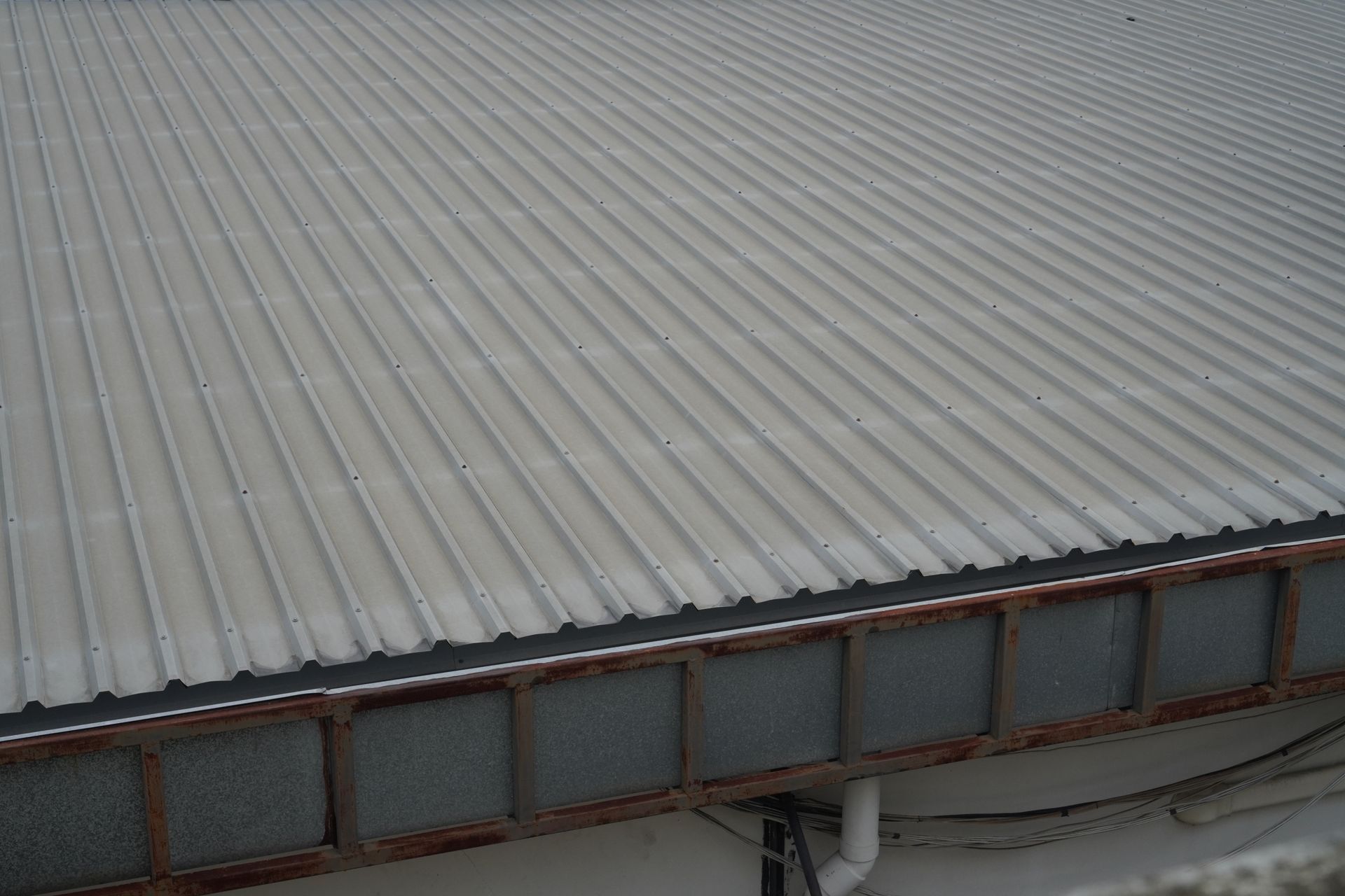 A red roof with a chimney on top of it.