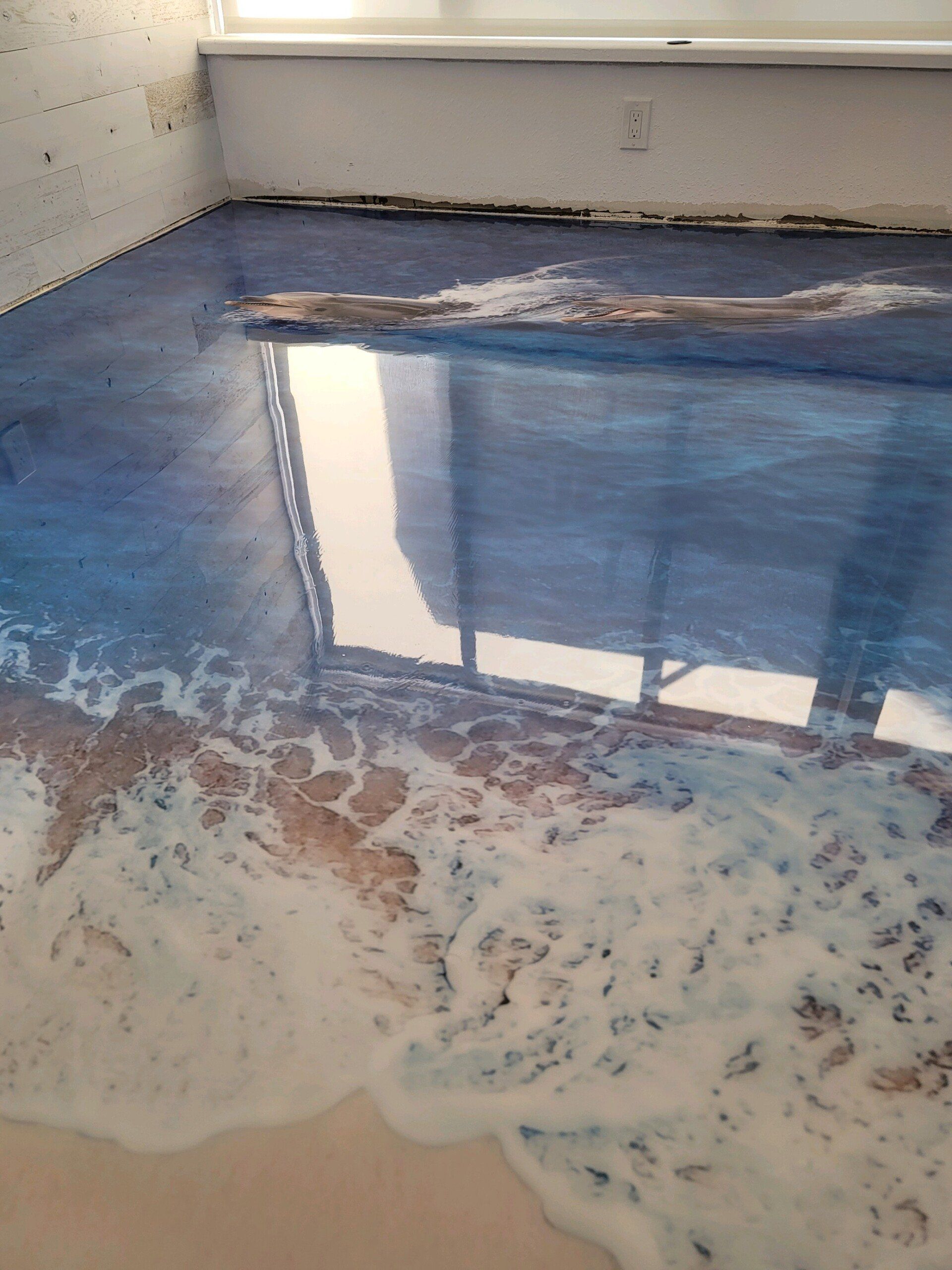 Partially flooded room floor with blue water and debris near white walls and a window reflection