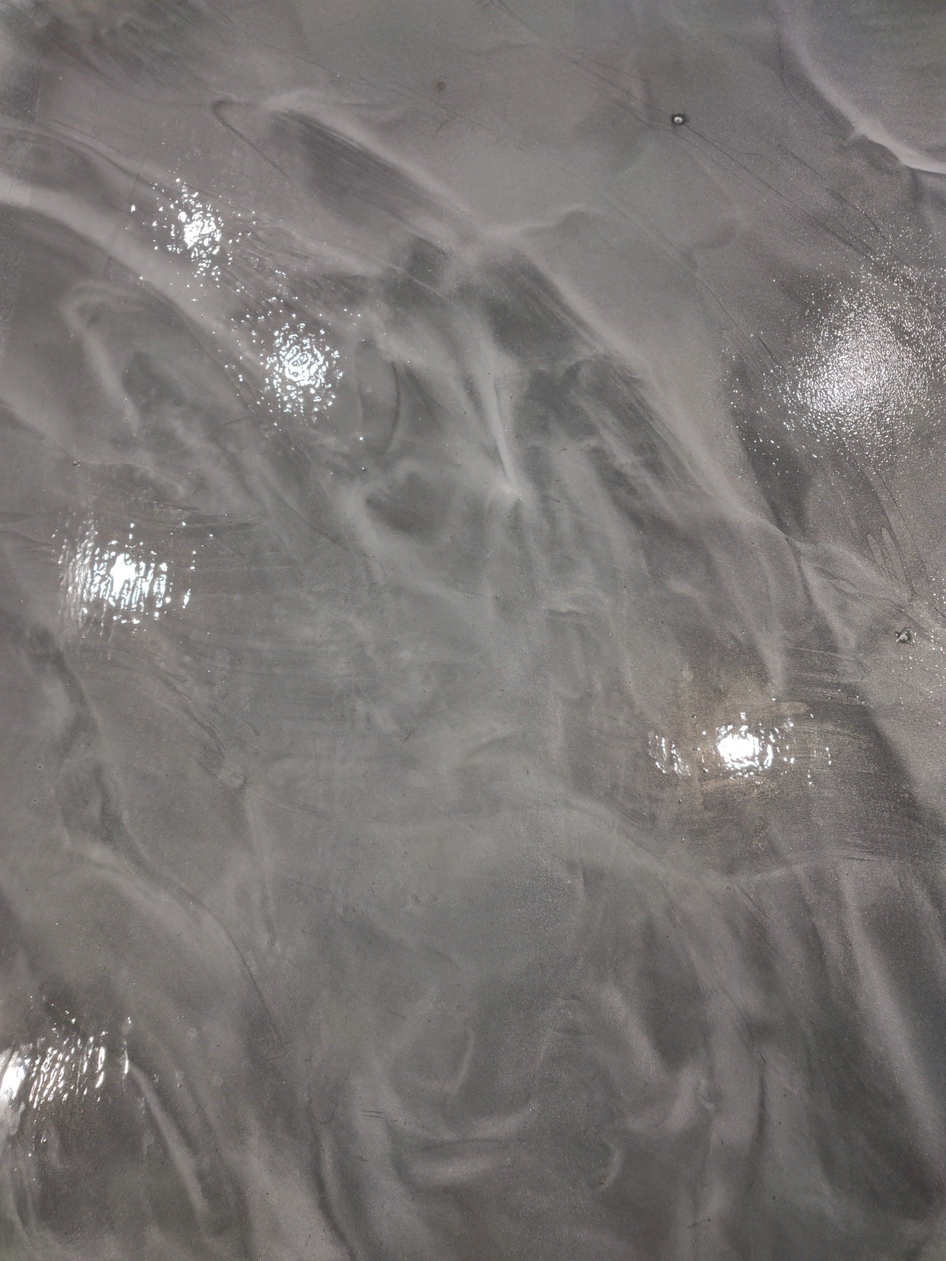 Close-up of gray marbled surface with several bright white speckles