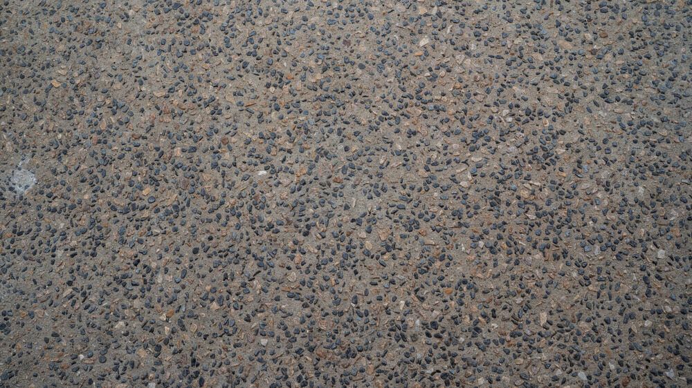 A Close Up of a Granite Counter Top With a Lot of Small Stones on It — Tiger Concrete ACT In Fadden, ACT