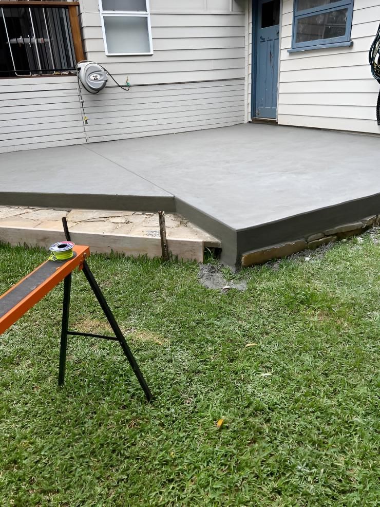 A Concrete Deck Is Being Built In The Backyard Of A House — Tiger Concrete ACT In Fadden, ACT
