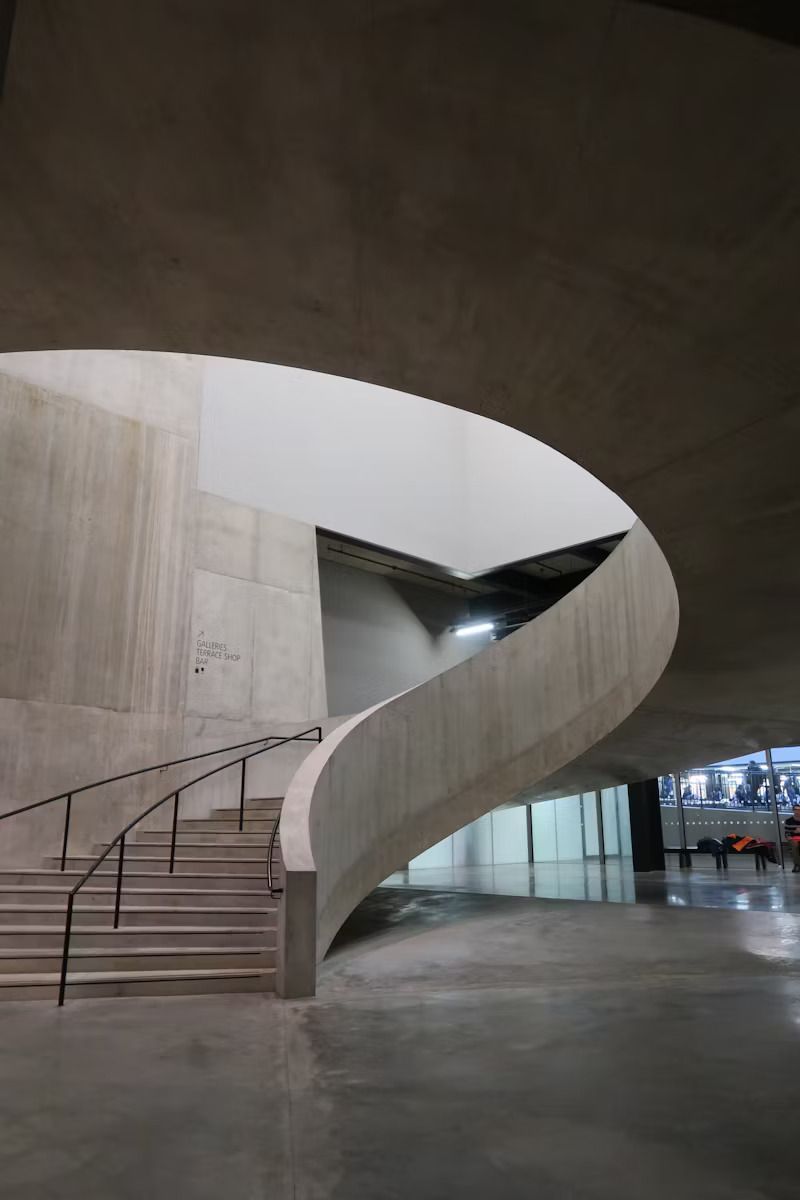 A Spiral Staircase in a Building With a Railing — Tiger Concrete ACT In Fadden, ACT