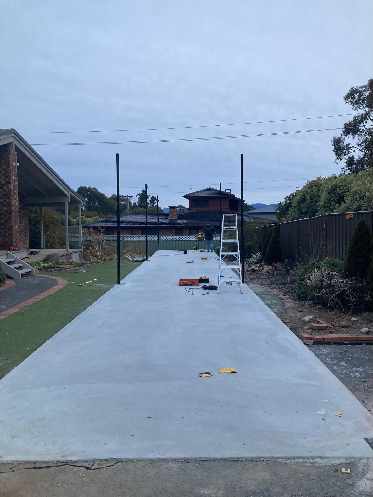 A Concrete Driveway Is Being Built In Front Of A House — Tiger Concrete ACT In Fadden, ACT