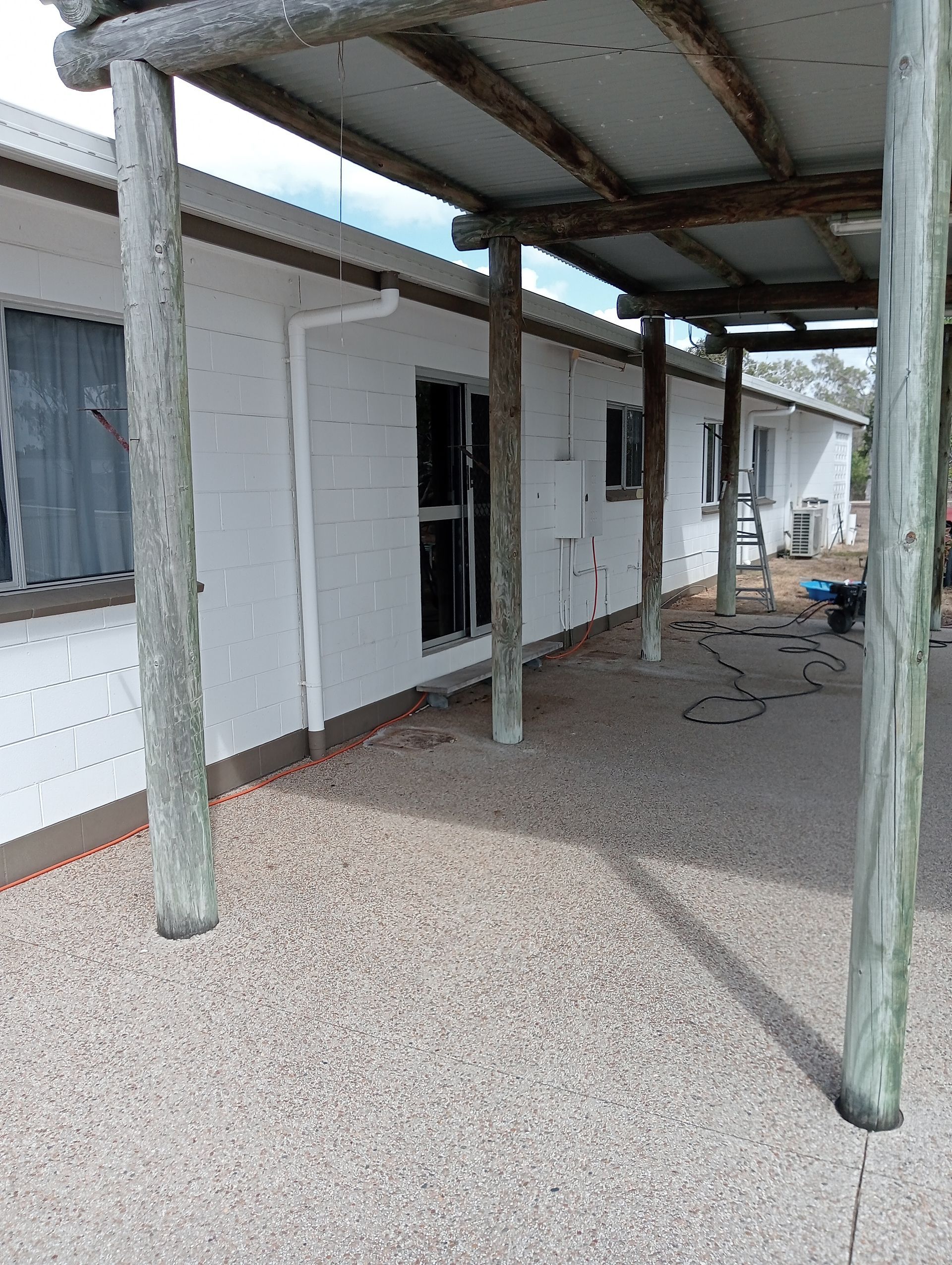 White Building With Gravel Patio — All Sparkles Cleaning Technology In Collinsville, QLD
